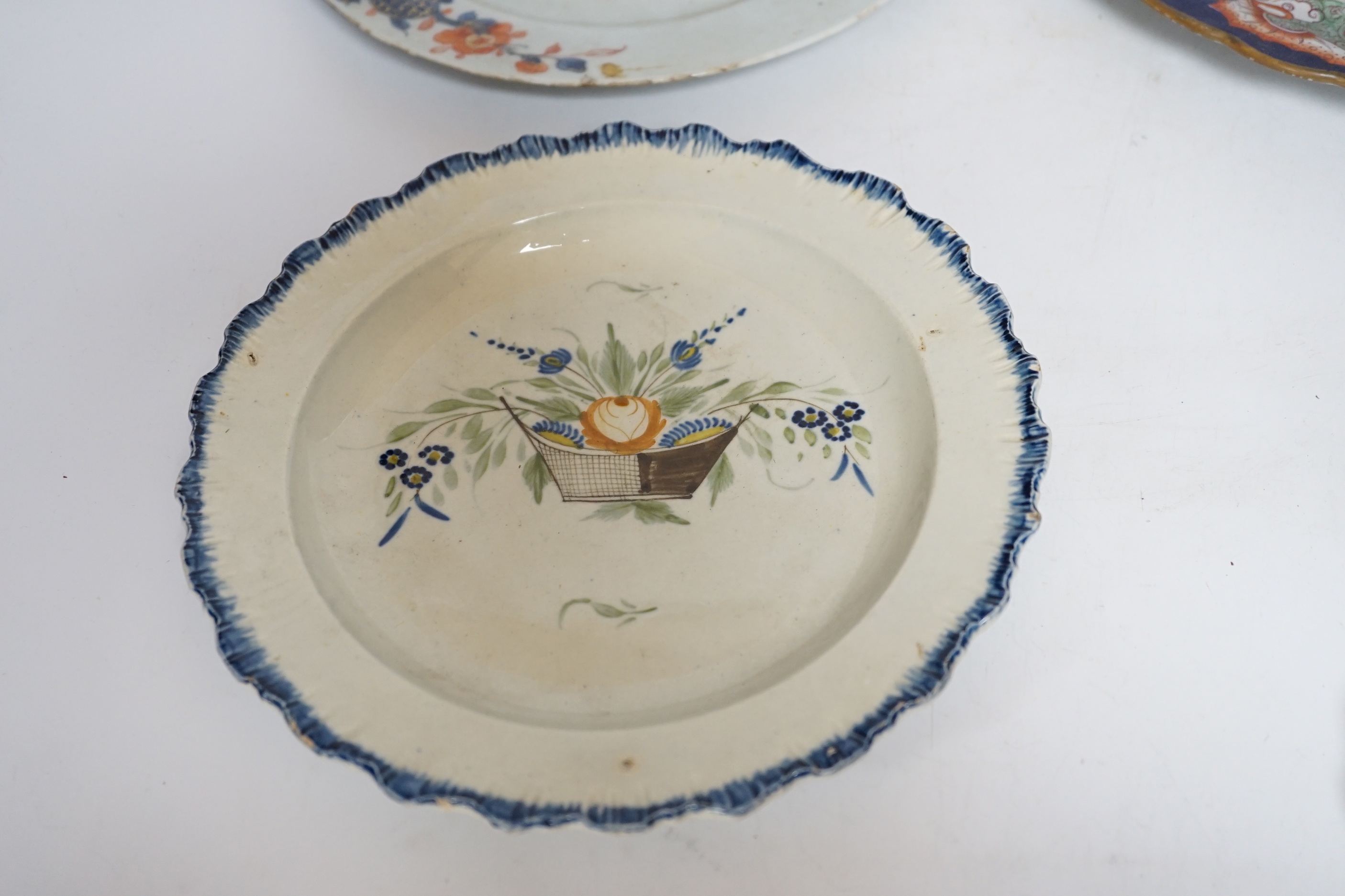 Two late 18th century pearlware Prattware plates, a Chinese export plate and an ironstone plate, largest 27cm in diameter